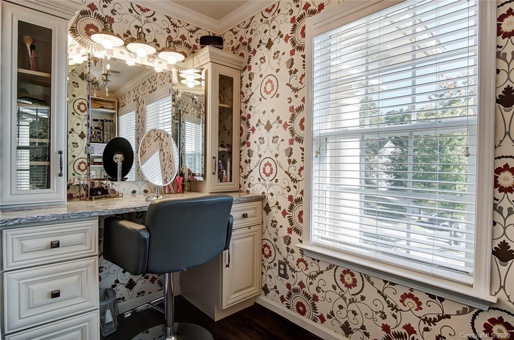 785 Fairway Point Drive Tega Cay, SC 29708 - Photo 25 of 46 a bathroom with a sink a mirror and next to a window