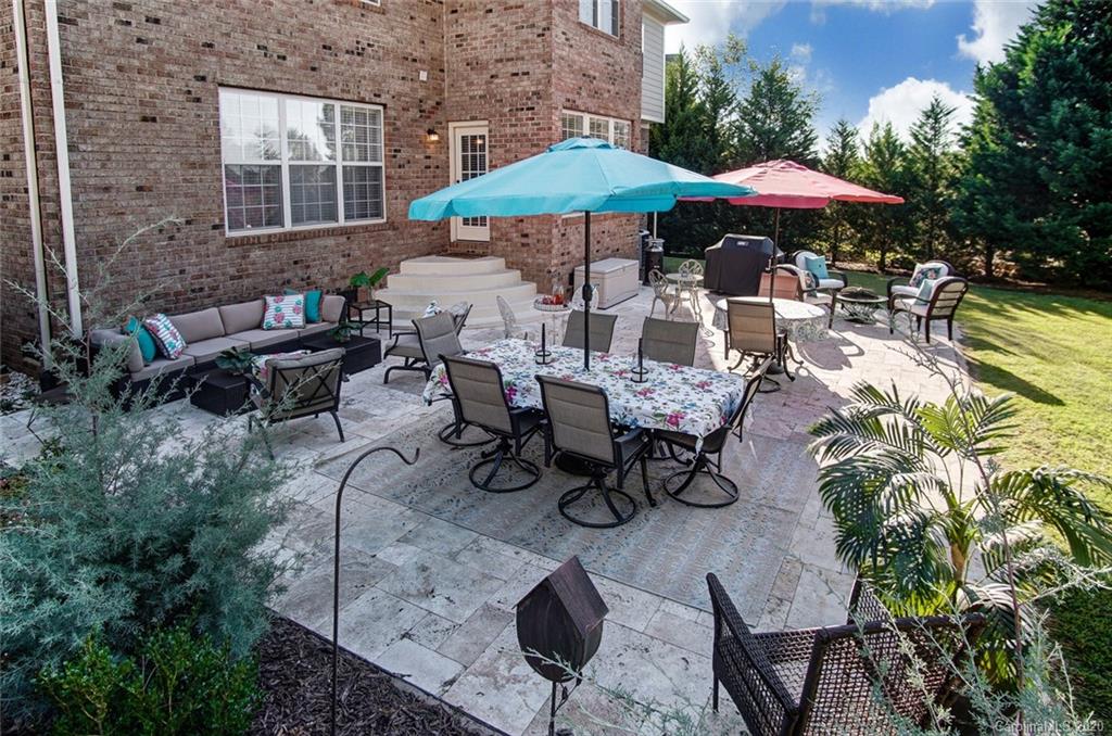 785 Fairway Point Drive Tega Cay, SC 29708 - Photo 36 of 46 a view of a patio with chairs and a table under an umbrella