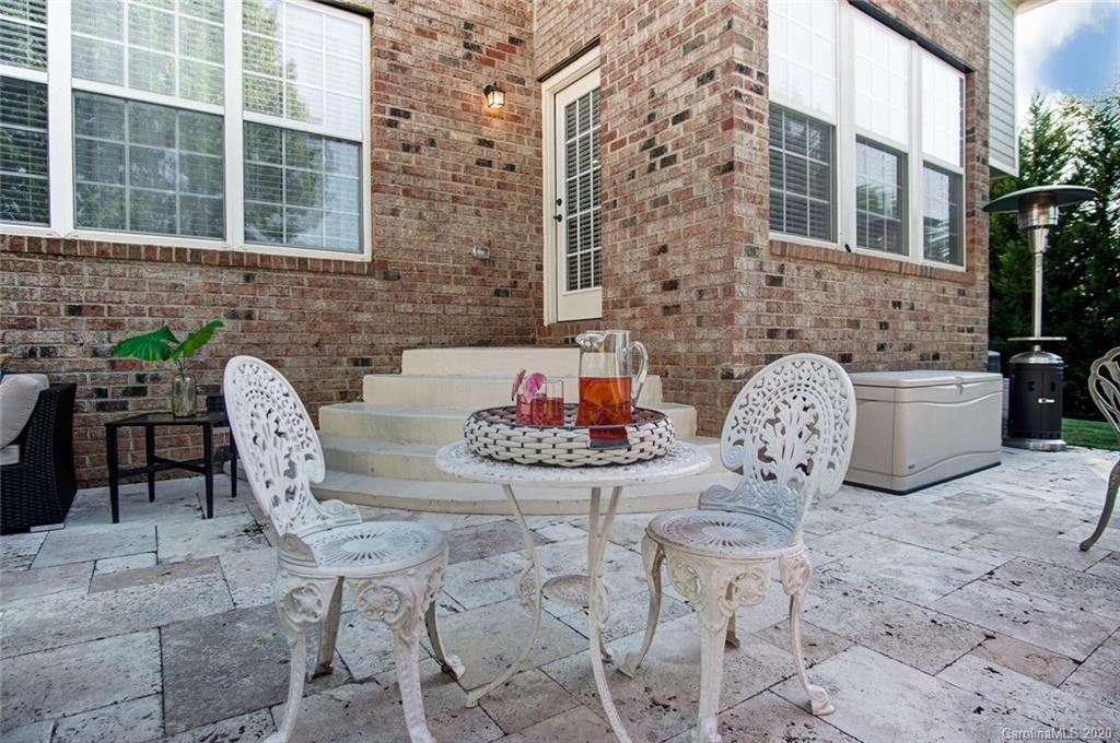 785 Fairway Point Drive Tega Cay, SC 29708 - Photo 38 of 46 a view of a patio with table and chairs and potted plants