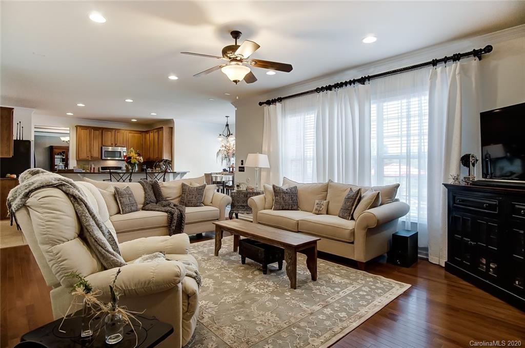 785 Fairway Point Drive Tega Cay, SC 29708 - Photo 9 of 46 a living room with furniture and a flat screen tv
