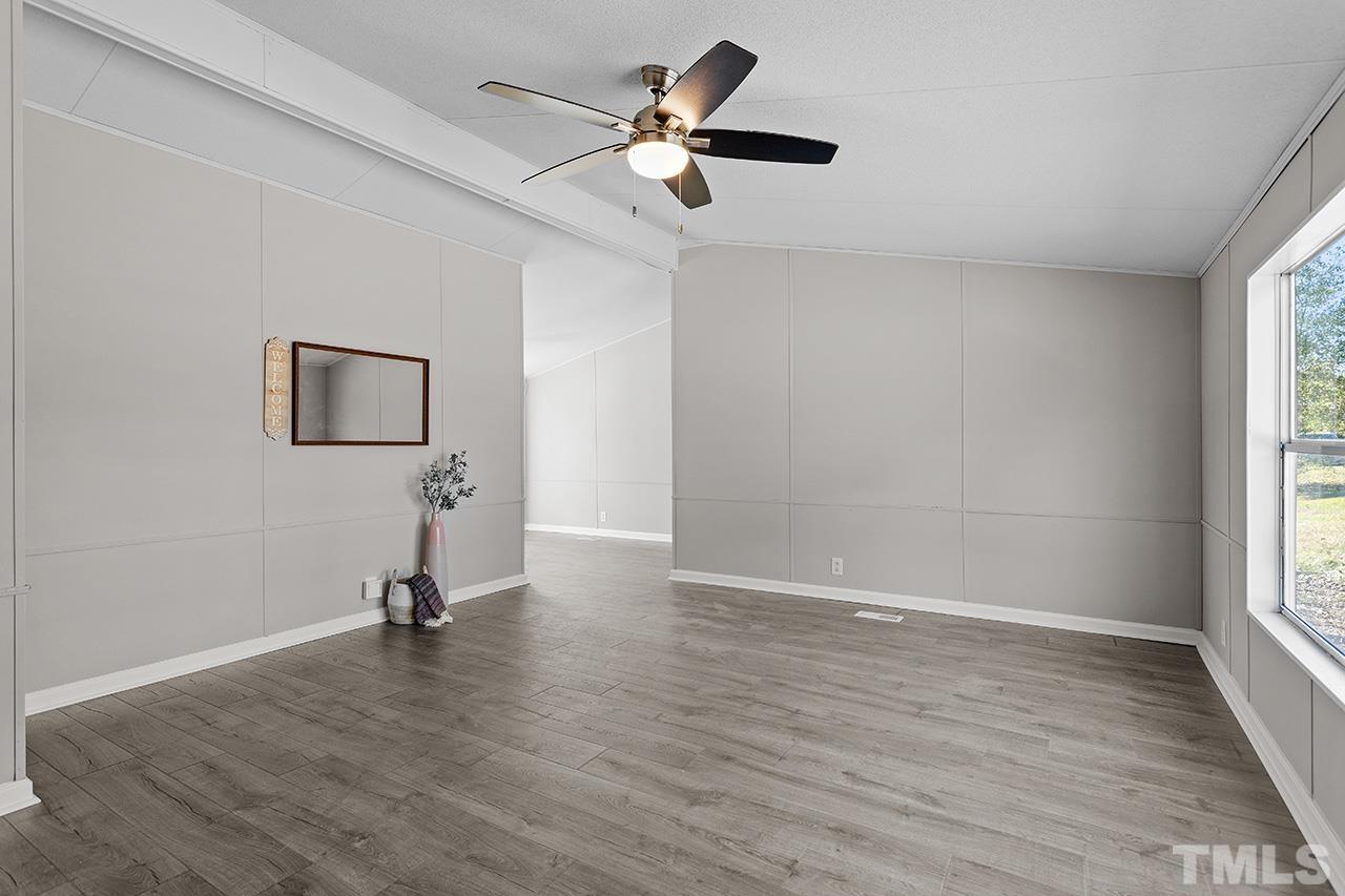 3208 State Road 2750 Willow Spring, NC 27592 - Photo 13 of 32 wooden floor in an empty room with a window