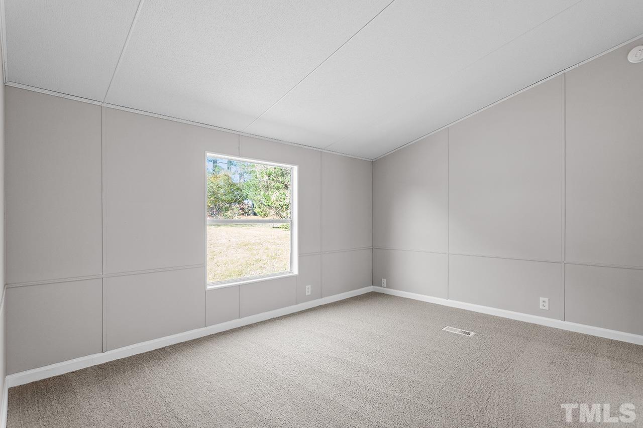 3208 State Road 2750 Willow Spring, NC 27592 - Photo 14 of 32 an empty room with windows