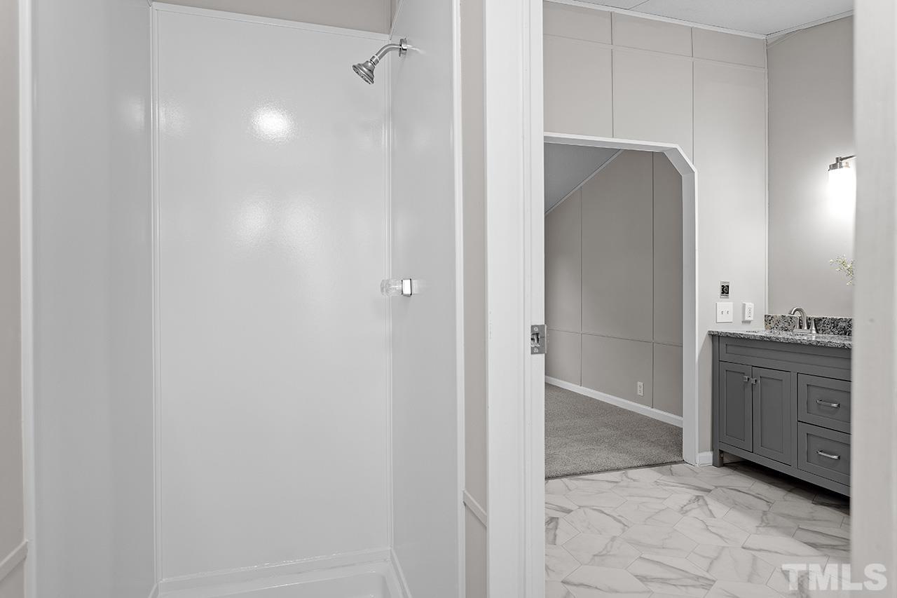 3208 State Road 2750 Willow Spring, NC 27592 - Photo 20 of 32 a bathroom with a sink and a mirror