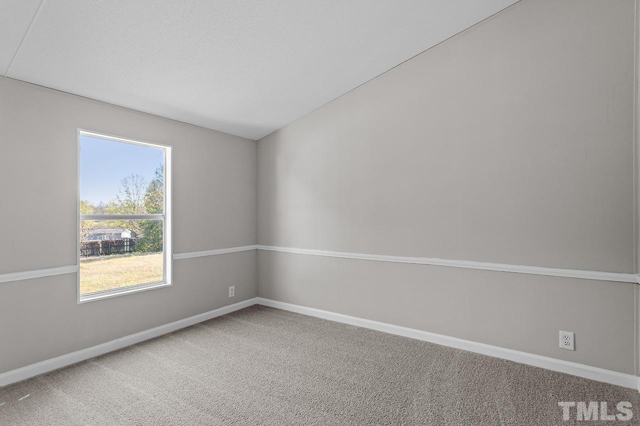 3208 State Road 2750 Willow Spring, NC 27592 - Photo 21 of 32 an empty room with a window