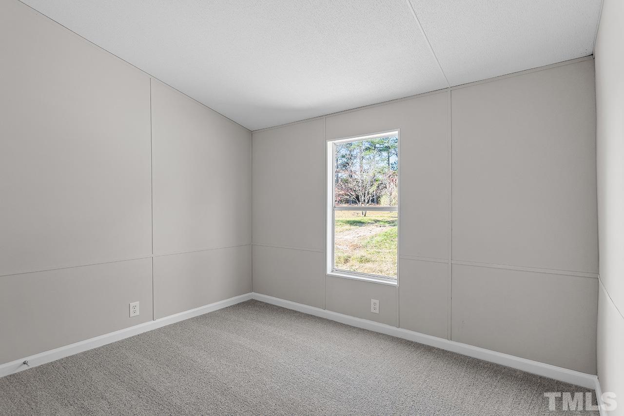 3208 State Road 2750 Willow Spring, NC 27592 - Photo 25 of 32 an empty room with a window