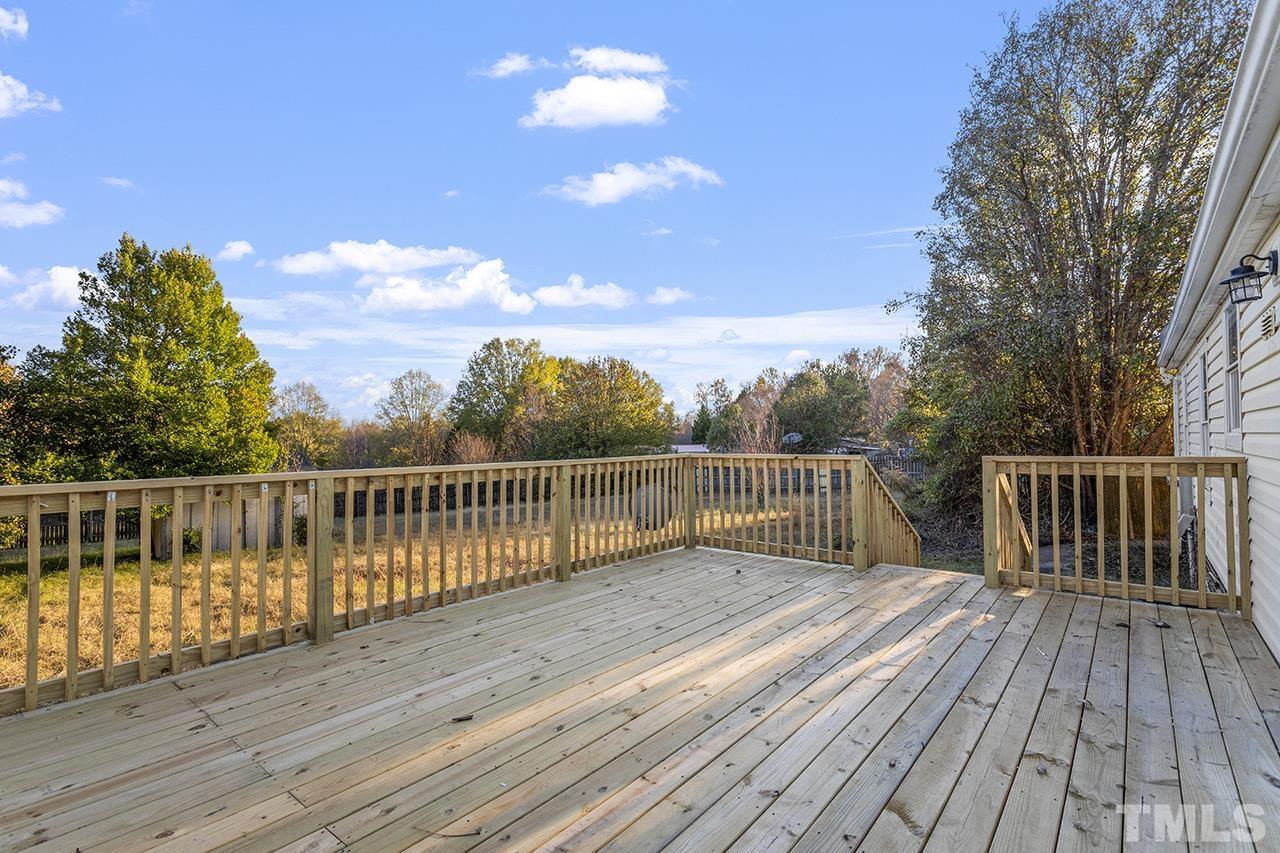3208 State Road 2750 Willow Spring, NC 27592 - Photo 28 of 32 a view of deck with wooden floor and fence with a bench