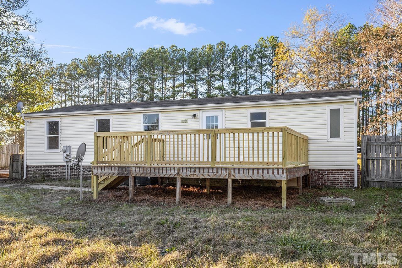 3208 State Road 2750 Willow Spring, NC 27592 - Photo 29 of 32 a view of a wooden deck and a yard