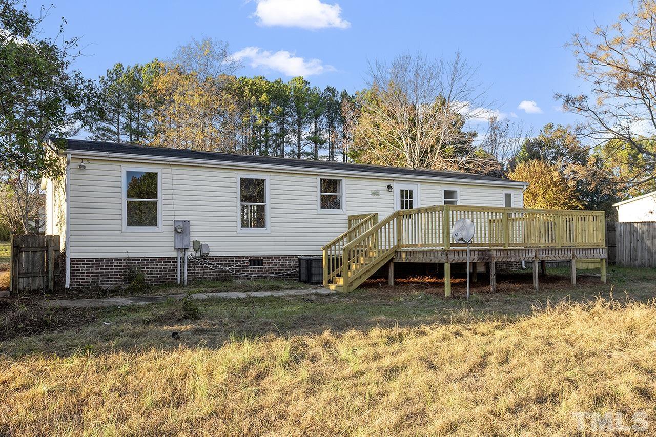 3208 State Road 2750 Willow Spring, NC 27592 - Photo 30 of 32 a view of a house with a yard and sitting area