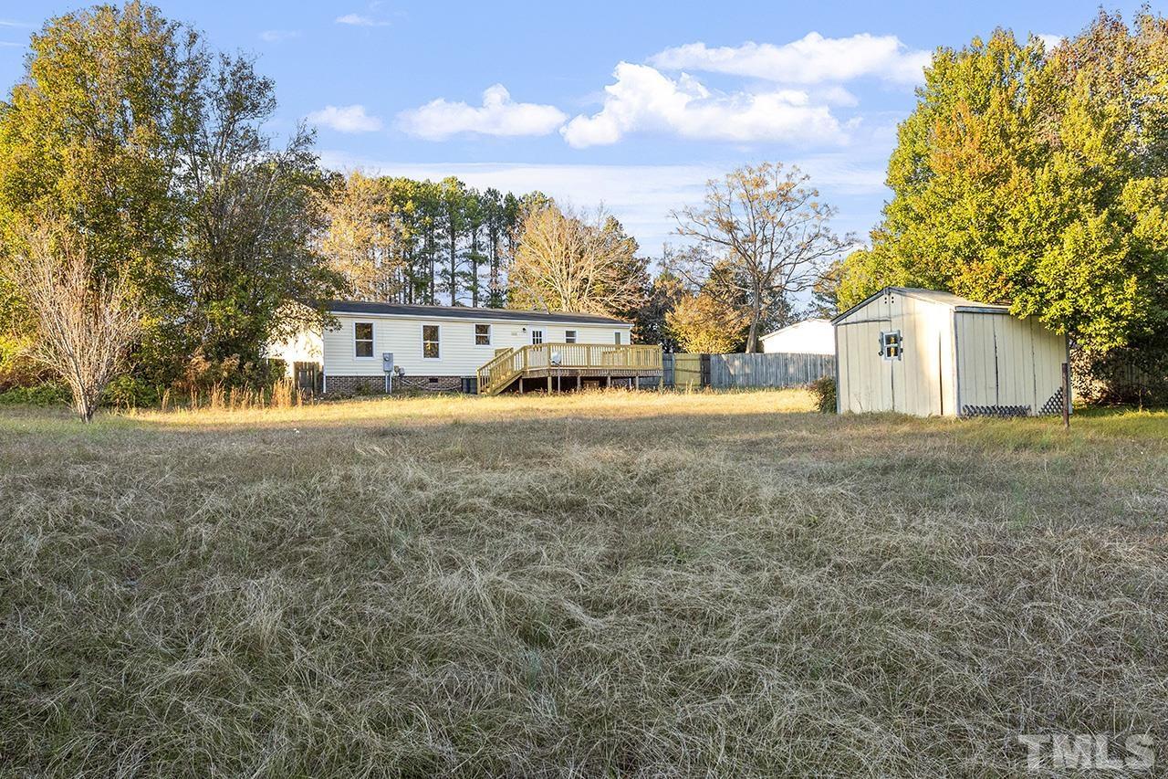 3208 State Road 2750 Willow Spring, NC 27592 - Photo 31 of 32 a view of an house with backyard and trees
