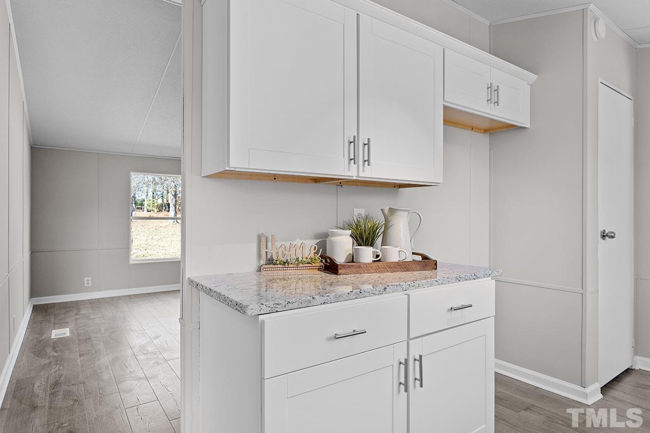 3208 State Road 2750 Willow Spring, NC 27592 - Photo 4 of 32 a kitchen with stainless steel appliances granite countertop a sink stove and cabinets