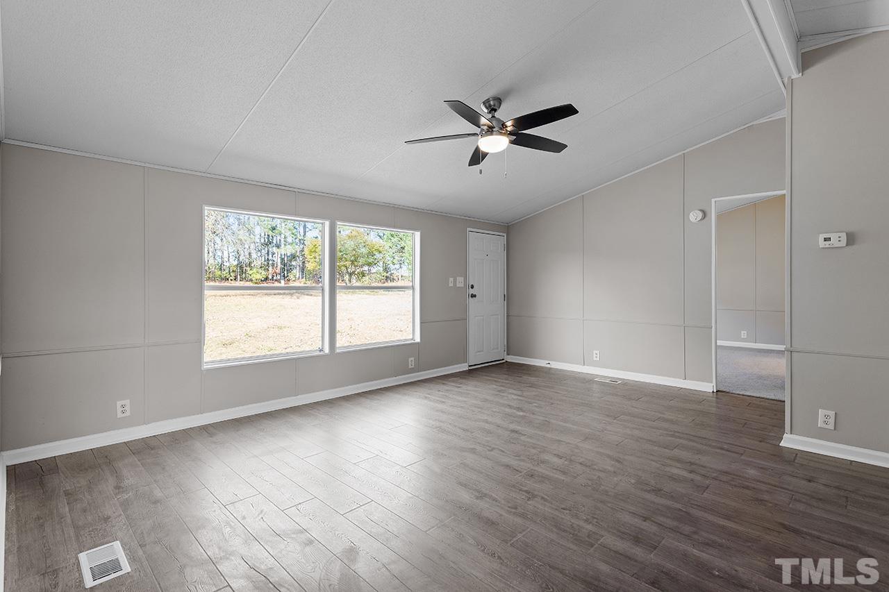 3208 State Road 2750 Willow Spring, NC 27592 - Photo 10 of 32 a view of empty room with wooden floor and fan