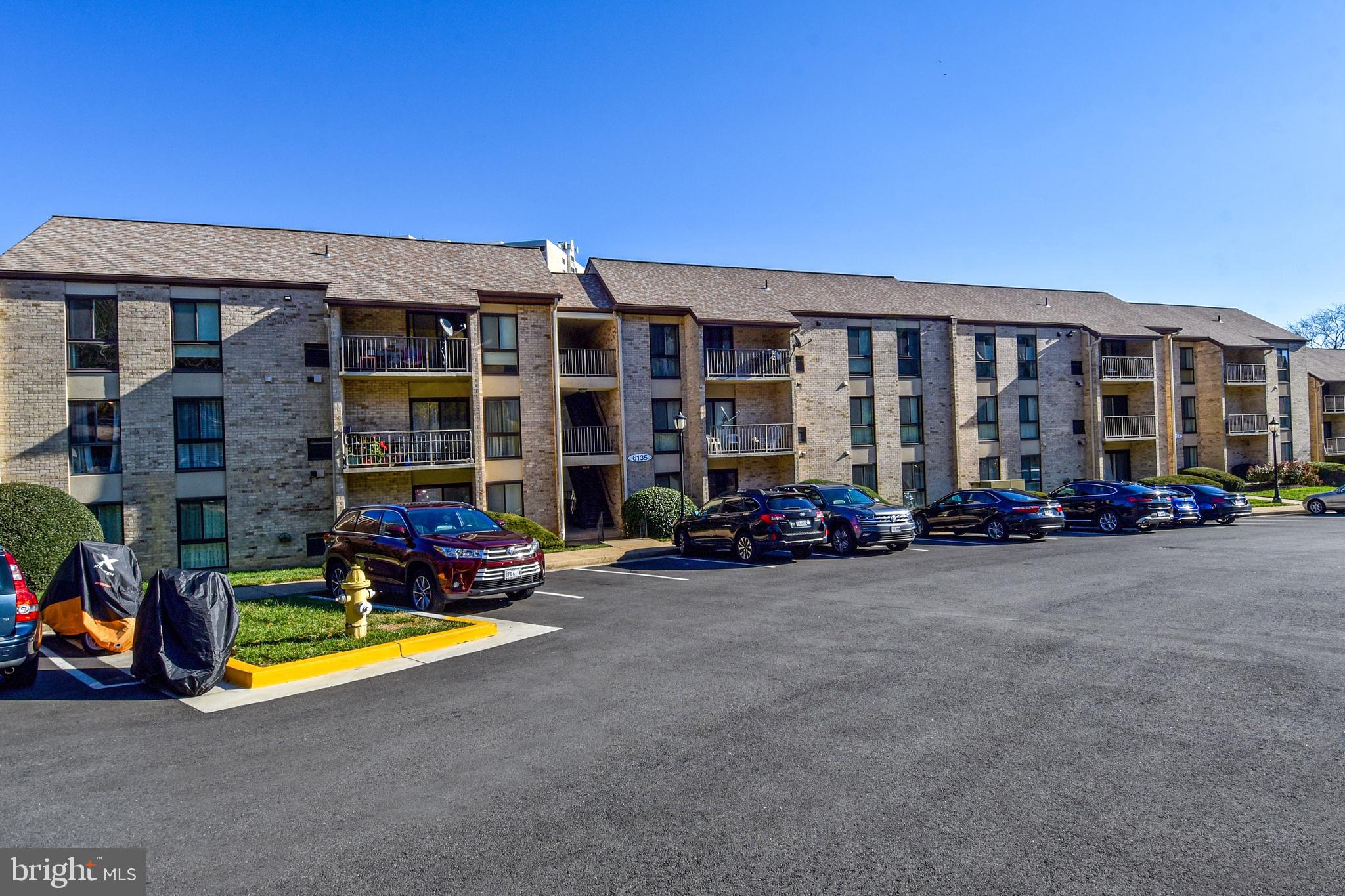 6135 Edsall Road, Unit I Alexandria, VA 22304 - Photo 31 of 47 a view of a building with many windows and a table