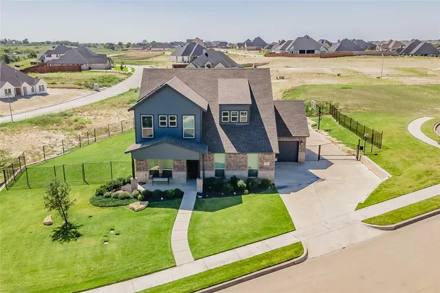 an aerial view of a house with a big yard