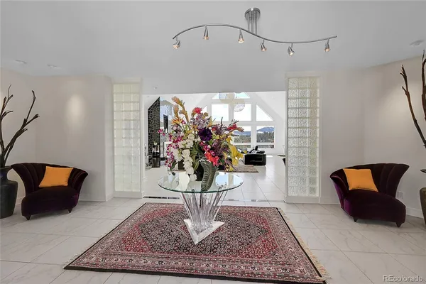 a bedroom with furniture and a large window