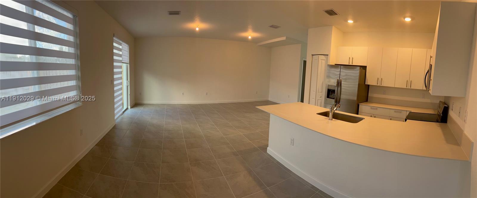 1406 Southeast 6th Road, Unit 1406 Homestead, FL 33034 - Photo 3 of 12 a bathroom with a double vanity sink a mirror and a shower