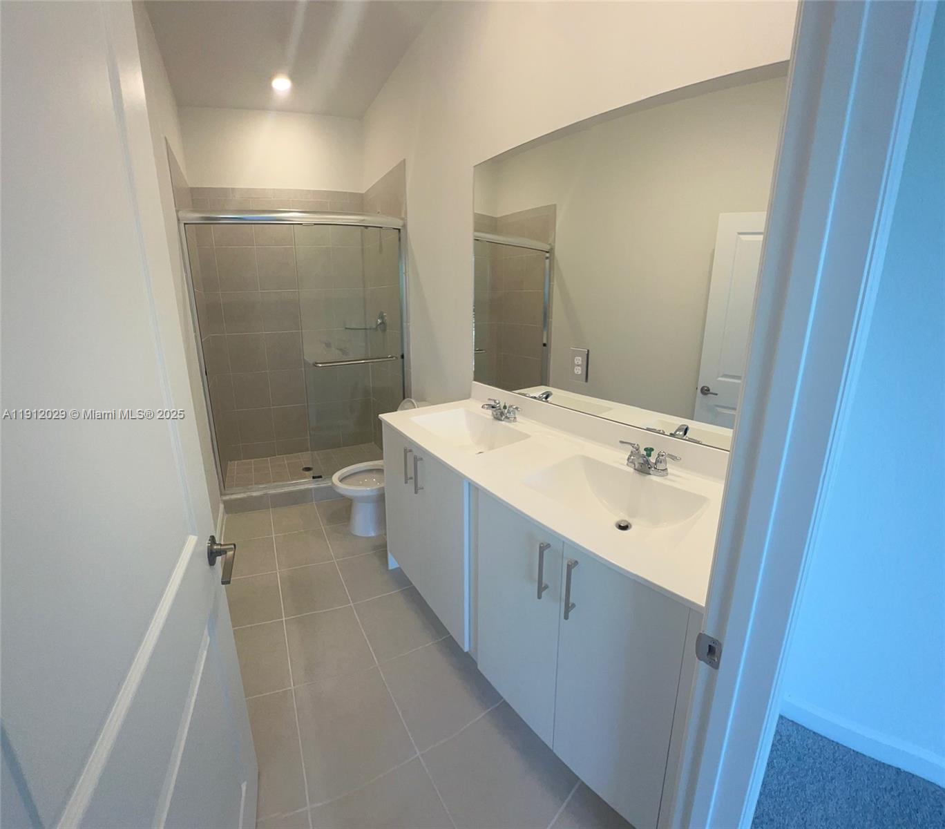 1406 Southeast 6th Road, Unit 1406 Homestead, FL 33034 - Photo 6 of 12 a bathroom with a sink a toilet and shower