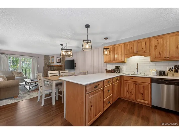 a kitchen with a sink stove and wooden cabinets