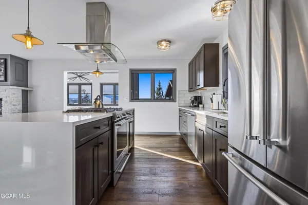 a kitchen with stainless steel appliances a sink stove and refrigerator