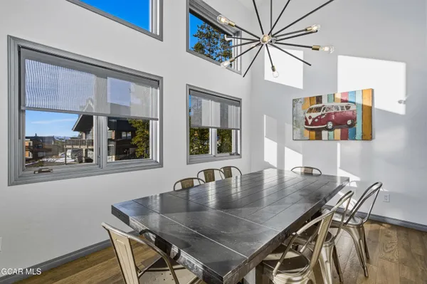 a view of a dining room with furniture and a chandelier