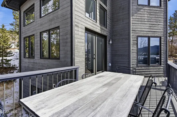 a view of a house with a wooden fence