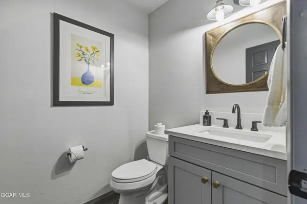 a bathroom with a toilet a sink and mirror