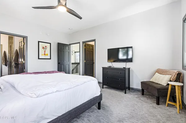 a bedroom with a bed and a television