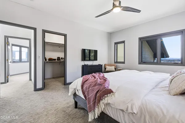 a bedroom with a bed and a flat screen tv