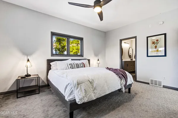 a bedroom with a bed and a chandelier