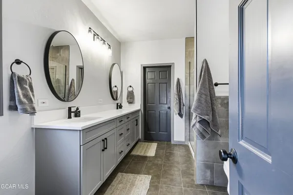 a bathroom with a double vanity sink and a mirror