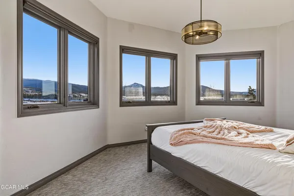 a bedroom with a large bed and a window