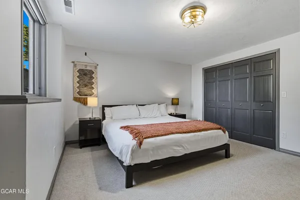 a bedroom with a bed and a window