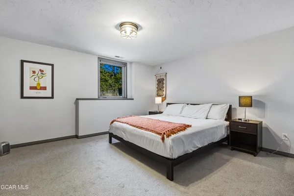 a spacious bedroom with a bed and window