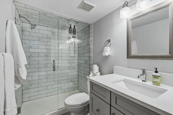 a bathroom with a sink toilet and shower