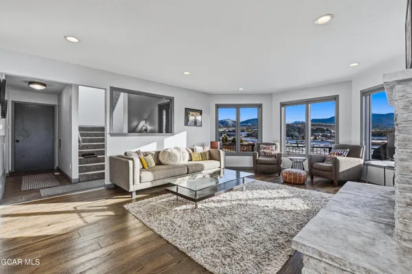 a living room with furniture wooden floor and a view of kitchen