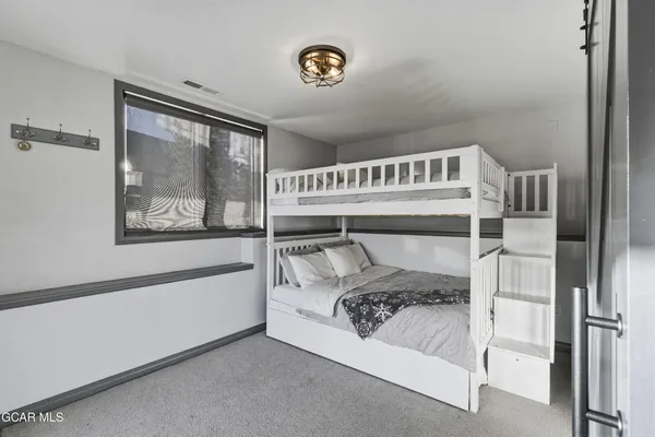 a bedroom with a large bed and a window