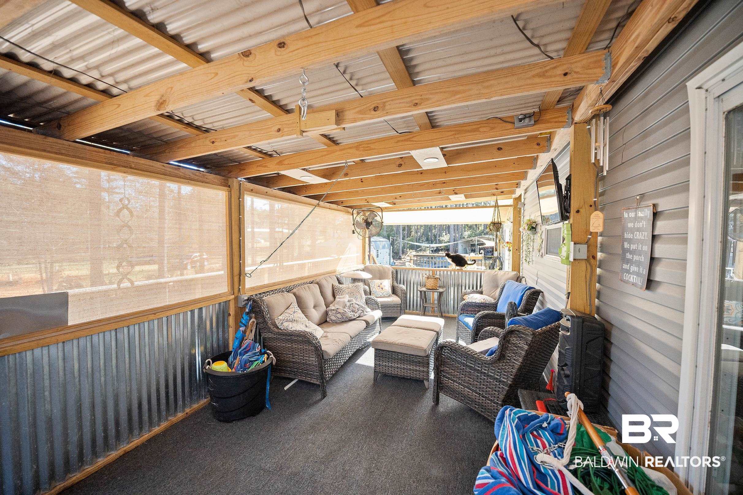 8630 Allison Lane Wilmer, AL 36587 - Photo 23 of 31 View of patio / terrace featuring outdoor lounge area and a sunroom