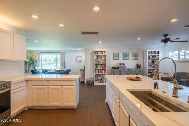 a living room with furniture wooden floor and a window