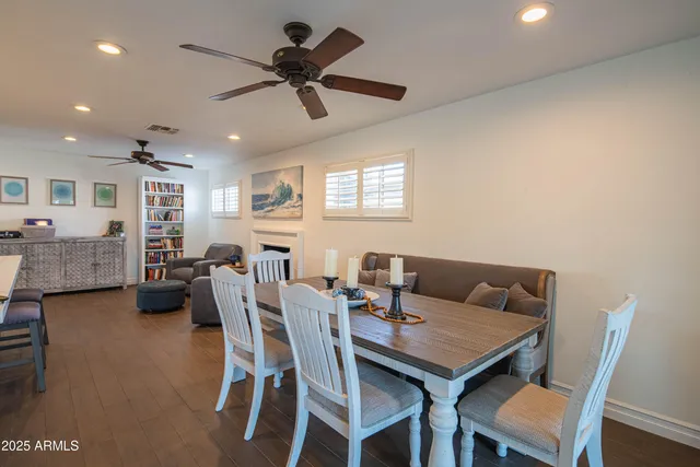 a view of a workspace with furniture and a bookshelf