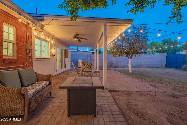 a backyard of a house with table and chairs