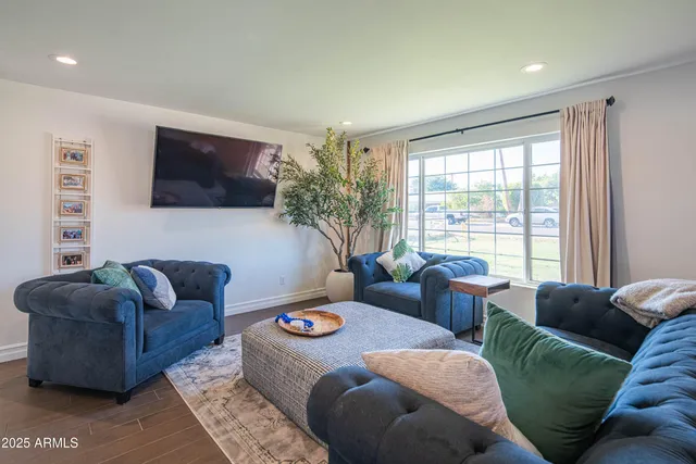 a living room with furniture and kitchen view
