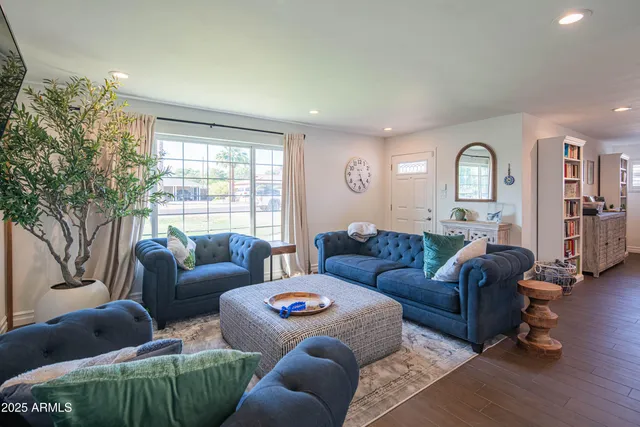 a large kitchen with kitchen island a stove a sink a refrigerator and couches