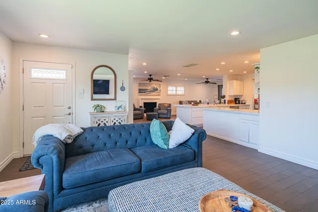 a large kitchen with kitchen island white cabinets and stainless steel appliances