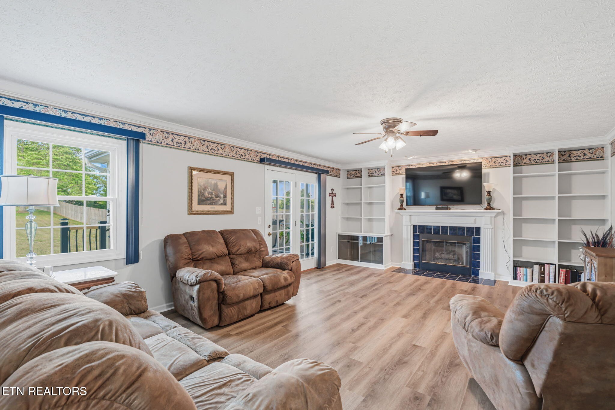 7030 Westerly Winds Road Knoxville, TN 37931 - Photo 12 of 40 a living room with furniture a fireplace and a flat screen tv