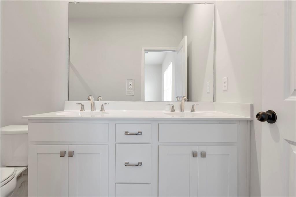 2244 Whistler Way Northeast Lawrenceville, GA 30043 - Photo 18 of 25 a bathroom with a sink and a mirror