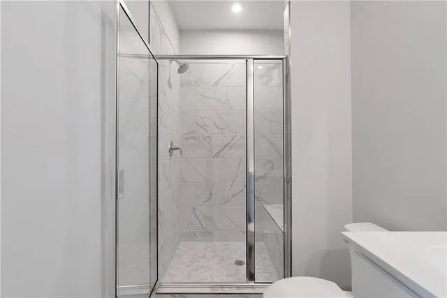 a bathroom with a shower and toilet