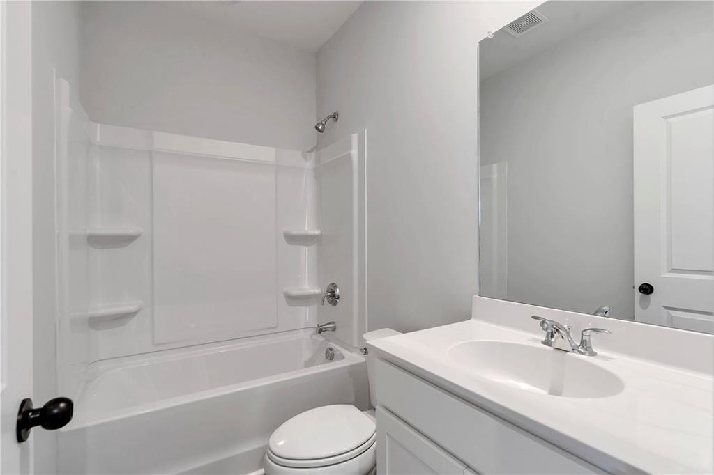 2244 Whistler Way Northeast Lawrenceville, GA 30043 - Photo 20 of 25 a bathroom with a toilet a sink and bathtub