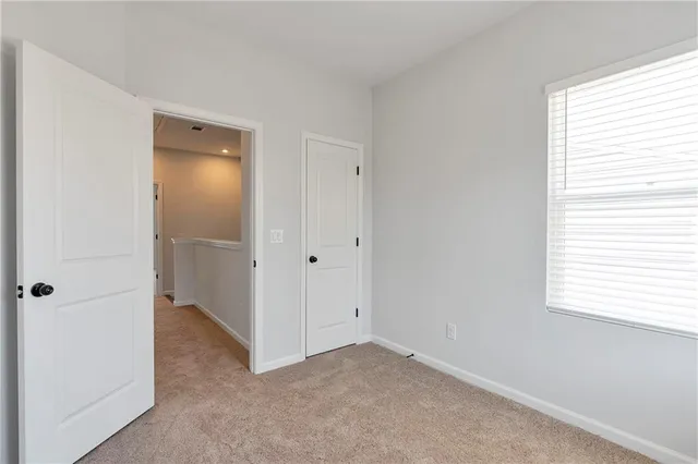 an empty room with windows and closet