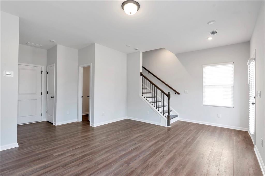 2244 Whistler Way Northeast Lawrenceville, GA 30043 - Photo 5 of 25 an empty room with wooden floor and windows