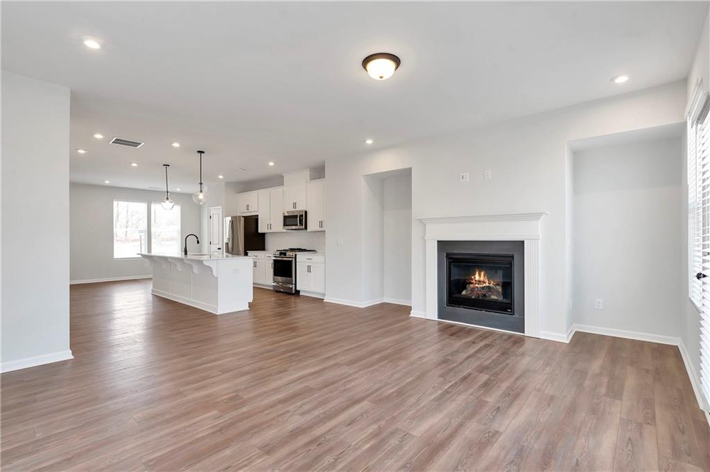 2244 Whistler Way Northeast Lawrenceville, GA 30043 - Photo 8 of 25 a view of an empty room and a kitchen with electric equipment