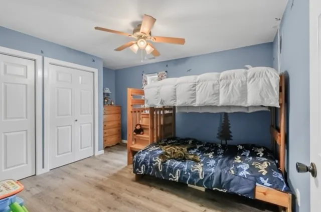 a bathroom with a granite countertop sink toilet and a mirror